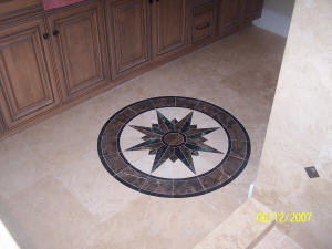 Custom travertine tile installation with marble medalion